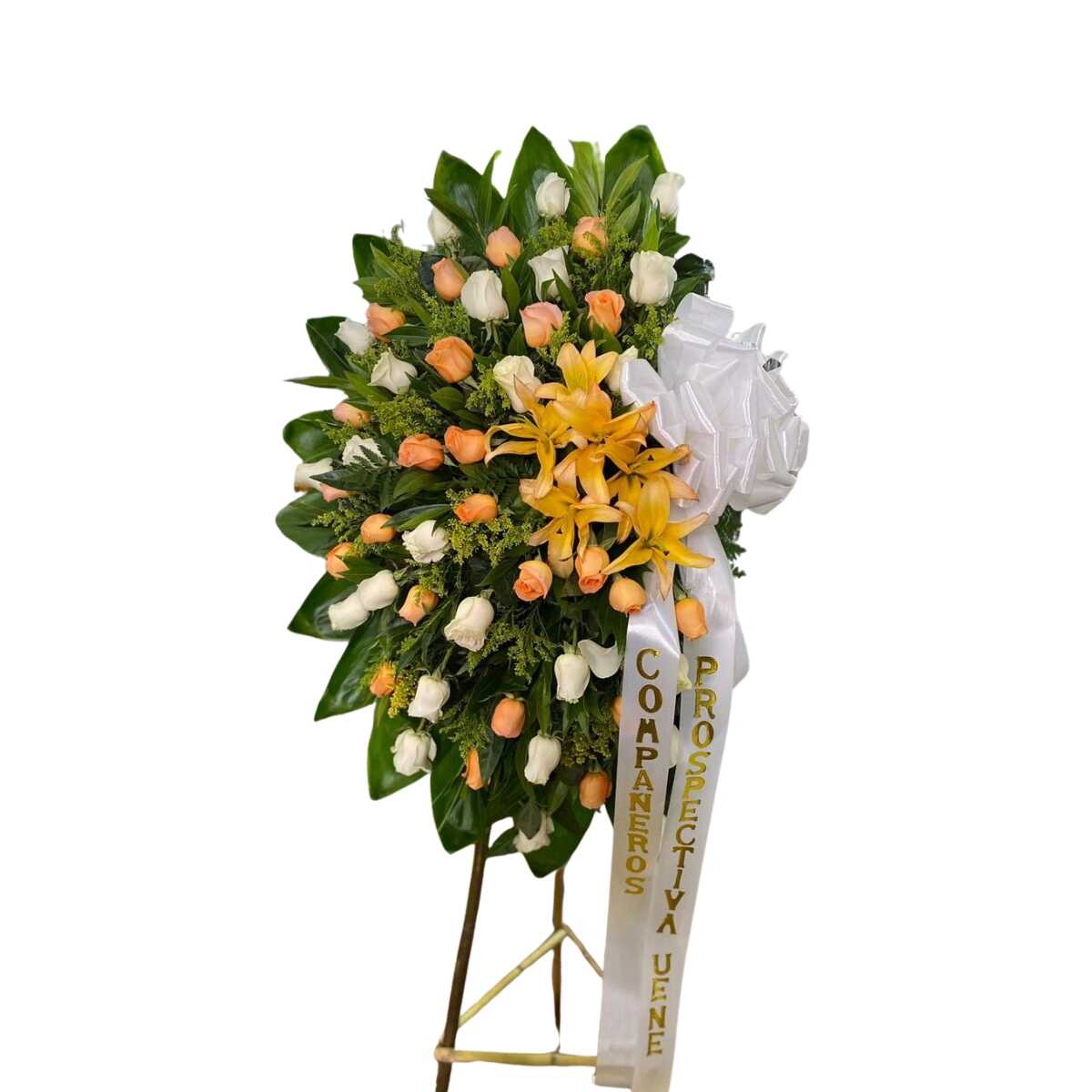 Corona fúnebre con lirios y rosas en tonos cálidos